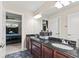 Bathroom boasts a double vanity with dark countertops and cabinetry, and blue tiled floors at 6230 E 56Th St, Indianapolis, IN 46226