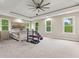Bedroom featuring a ceiling fan, large windows, and workout equipment at 6230 E 56Th St, Indianapolis, IN 46226
