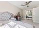 Bedroom featuring a ceiling fan, vanity, and mirrored closet at 6230 E 56Th St, Indianapolis, IN 46226