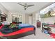 Bedroom featuring a ceiling fan, TV, and closet with mirrored doors at 6230 E 56Th St, Indianapolis, IN 46226