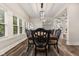 Elegant dining room features hardwood floors, large windows, stylish light fixture, and seating for six at 6230 E 56Th St, Indianapolis, IN 46226