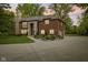 Stately brick home with stone accents, manicured landscaping, and a circular driveway at 6230 E 56Th St, Indianapolis, IN 46226