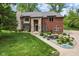 Charming brick home with a landscaped front yard and a beautiful stone water feature at 6230 E 56Th St, Indianapolis, IN 46226