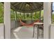 Relaxing gazebo featuring a hammock, ceiling fan, and open views of the lush greenery at 6230 E 56Th St, Indianapolis, IN 46226