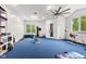 Bright home gym equipped with exercise equipment, large windows for natural light and fan at 6230 E 56Th St, Indianapolis, IN 46226