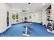 Home gym, offering ample space for workout equipment, with a fan and natural light from large windows at 6230 E 56Th St, Indianapolis, IN 46226