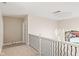 Upstairs hallway featuring an ornate railing and modern light fixture, creating an open and bright transition at 6230 E 56Th St, Indianapolis, IN 46226
