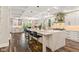 Open kitchen with a large island, pendant lighting, stainless steel appliances, and bar stool seating at 6230 E 56Th St, Indianapolis, IN 46226