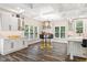 Bright kitchen and dining area, featuring a stylish island, bar seating, and modern lighting at 6230 E 56Th St, Indianapolis, IN 46226
