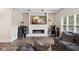 Cozy living room featuring a fireplace with a large screen TV and comfortable seating at 6230 E 56Th St, Indianapolis, IN 46226