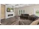 Spacious living room with modern fireplace, large window, and comfortable seating arrangement at 6230 E 56Th St, Indianapolis, IN 46226