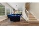 Stylish living room with plush blue sofas, hardwood floors, and a staircase at 6230 E 56Th St, Indianapolis, IN 46226