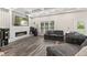 Living room featuring a modern fireplace, custom wall decor, and large windows for natural light at 6230 E 56Th St, Indianapolis, IN 46226