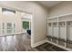 Well organized mudroom with coat rack, storage cubbies, and stained wood flooring at 6230 E 56Th St, Indianapolis, IN 46226