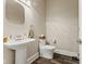 Elegant powder room with pedestal sink, decorative mirror, and modern fixtures at 6230 E 56Th St, Indianapolis, IN 46226