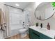 Modern bathroom with green vanity, black accents, and a shower-tub combination at 650 Overstreet St, Franklin, IN 46131