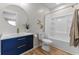 Modern bathroom with navy vanity, gold accents, and a shower-tub combination at 650 Overstreet St, Franklin, IN 46131