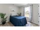 Cozy bedroom with a blue comforter, patterned curtains, and ample natural light at 650 Overstreet St, Franklin, IN 46131