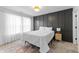 Stylish bedroom with dark accent wall, plush carpeting, and bright natural light at 650 Overstreet St, Franklin, IN 46131
