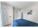Well-lit bedroom with a blue comforter, plush carpeting, and a double door closet at 650 Overstreet St, Franklin, IN 46131