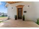 Covered front porch featuring a wooden deck, stylish lighting, and black front door at 650 Overstreet St, Franklin, IN 46131
