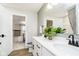 Bathroom vanity featuring double sinks, white cabinets and modern fixtures at 6551 Ambassador Dr, Plainfield, IN 46168