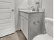 Bathroom sink and vanity with granite counter top, cabinets, and toilet at 6683 Halsey St, Zionsville, IN 46077