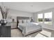 Bright bedroom with plush carpet, large windows, and stylish gray accents for a relaxing retreat at 6683 Halsey St, Zionsville, IN 46077