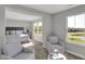 Spacious bedroom featuring plush chairs, a large window, and natural light perfect for relaxation and comfort at 6683 Halsey St, Zionsville, IN 46077