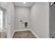 Neat laundry room with gray tile floors and hook ups at 6683 Halsey St, Zionsville, IN 46077