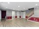 View of a spacious basement area with luxury vinyl flooring and trimmed walls with a water closet at 6916 Havenmoor Pl, Indianapolis, IN 46250
