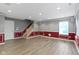 View of a spacious basement area with luxury vinyl flooring, trimmed walls and a staircase at 6916 Havenmoor Pl, Indianapolis, IN 46250