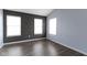 Well-lit bedroom features three windows, and neutral paint, providing a serene and airy atmosphere at 6916 Havenmoor Pl, Indianapolis, IN 46250