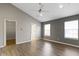 Bedroom showcasing hardwood flooring, two windows, and neutral walls at 6916 Havenmoor Pl, Indianapolis, IN 46250
