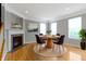 Inviting dining area boasts a fireplace, a wood table with seating for four, and bright natural light at 6916 Havenmoor Pl, Indianapolis, IN 46250