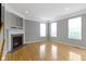 Bright room featuring neutral walls, wood floors, and a fireplace with mantel at 6916 Havenmoor Pl, Indianapolis, IN 46250