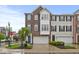 Charming brick townhome featuring a two-car garage and a neatly landscaped front yard at 6916 Havenmoor Pl, Indianapolis, IN 46250