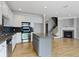 The kitchen has white cabinets, stainless steel appliances, and a granite island that overlooks the living room at 6916 Havenmoor Pl, Indianapolis, IN 46250