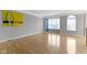 Bright room featuring neutral walls, wood floors, and large windows providing plenty of natural light at 6916 Havenmoor Pl, Indianapolis, IN 46250