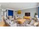 Bright living room showcasing gray walls, neutral furniture with bright pillows, and a decorative rug at 6916 Havenmoor Pl, Indianapolis, IN 46250