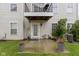 View of a concrete patio with sliding glass door and a balcony with a grill at 6916 Havenmoor Pl, Indianapolis, IN 46250