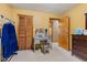 Bedroom featuring a vanity with lighted mirror, closet with louvered doors and a brown dresser at 6925 W State Road 128, Frankton, IN 46044