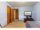 Bedroom with light blue walls, wood trim and doors, television and dresser against the far wall at 6925 W State Road 128, Frankton, IN 46044