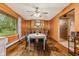 Dining room featuring wood floors, matching furniture set, natural light, and orange walls at 6925 W State Road 128, Frankton, IN 46044