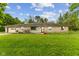 Charming single-story home with stone facade, attached garage, and a spacious front lawn at 6925 W State Road 128, Frankton, IN 46044