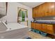 Well-equipped laundry room featuring washer, dryer, cabinet storage, and an exterior door for easy access at 6925 W State Road 128, Frankton, IN 46044