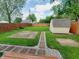Spacious backyard featuring a stone pathway, storage shed, and a well-maintained lawn at 704 E Perry St, Indianapolis, IN 46227