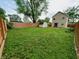 Spacious backyard featuring a shed, lush lawn, and a privacy fence surrounding the property at 704 E Perry St, Indianapolis, IN 46227