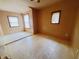 An ample bedroom with light brown walls, two windows, and wood floors creates a relaxing retreat at 704 E Perry St, Indianapolis, IN 46227