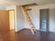Bedroom featuring ladder for access to upper space, and two entryways to other rooms at 704 E Perry St, Indianapolis, IN 46227
